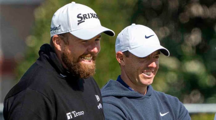 Shane Lowry (left) and Rory McIlroy smile on the fourth hole during a practice round of the 2023 British Open.